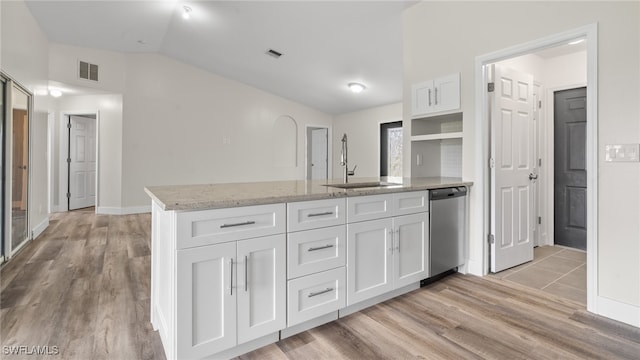 kitchen featuring white cabinetry, light wood-type flooring, sink, vaulted ceiling, and dishwasher