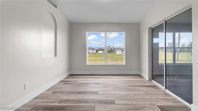 spare room with light hardwood / wood-style floors