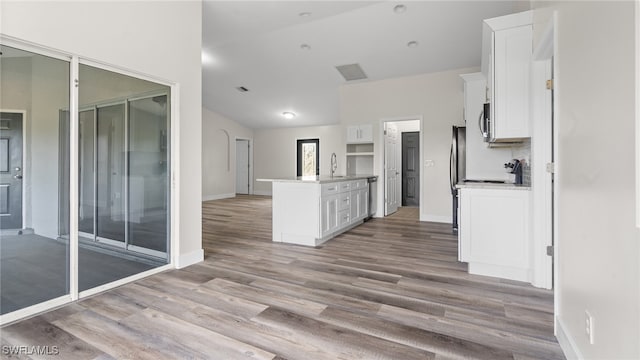 kitchen with white cabinetry, sink, and light wood-type flooring