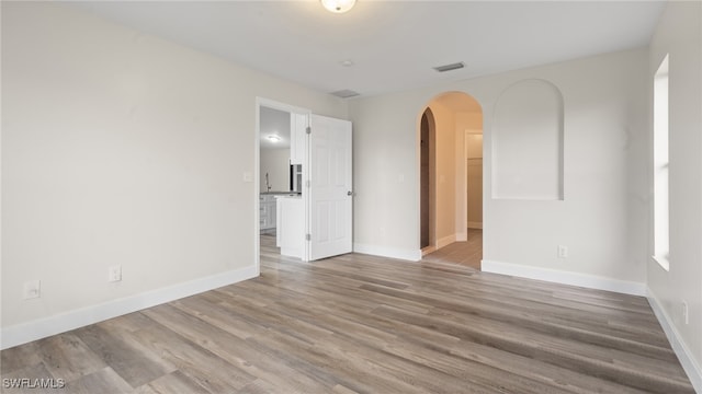 empty room with hardwood / wood-style floors