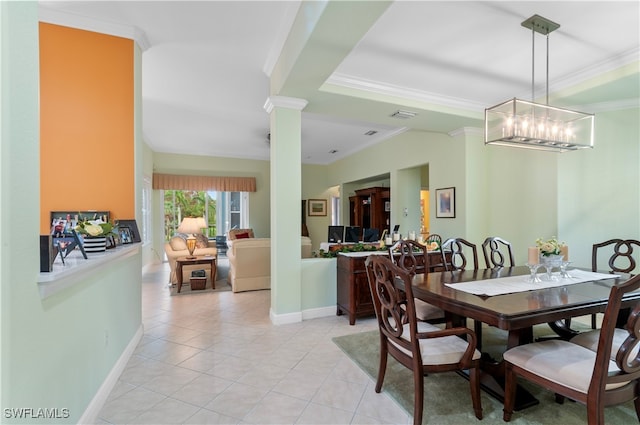 tiled dining space with decorative columns, a chandelier, and crown molding