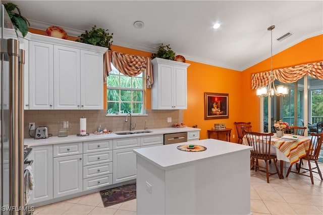 kitchen with white cabinetry, plenty of natural light, lofted ceiling, and sink