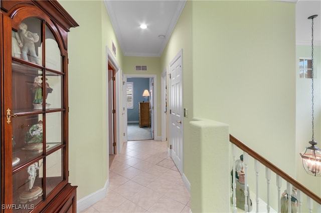 corridor with ornamental molding and light tile patterned floors