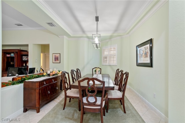 tiled dining area featuring crown molding