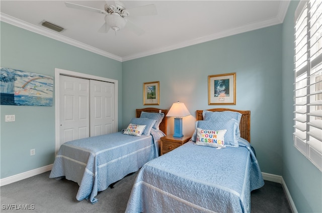 bedroom with ornamental molding, carpet flooring, ceiling fan, and a closet