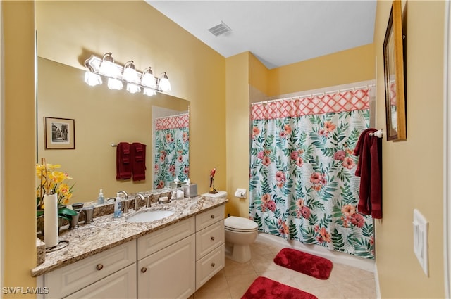 bathroom featuring toilet, vanity, and tile patterned floors