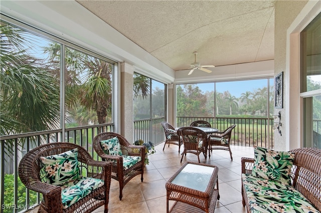 sunroom / solarium featuring ceiling fan