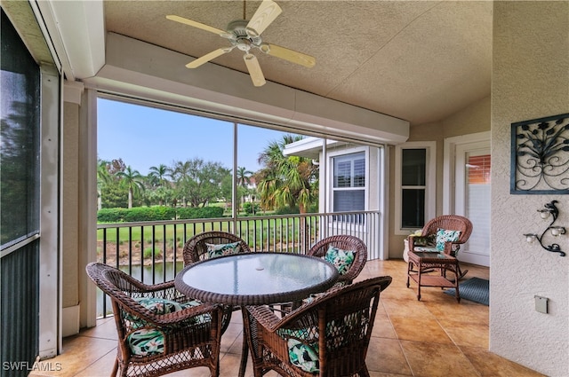 sunroom with ceiling fan and lofted ceiling