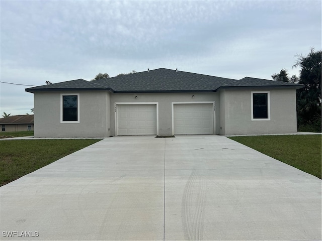 view of front of home with a garage and a front lawn