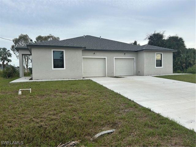 view of front of property with a front lawn and a garage