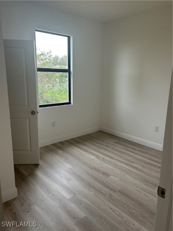 empty room with light hardwood / wood-style flooring