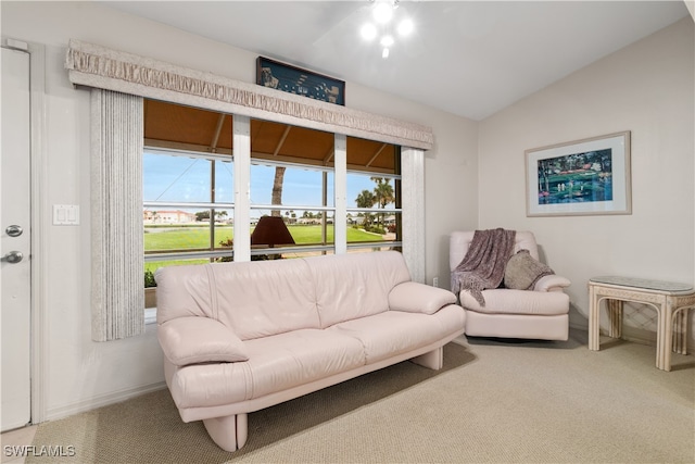 carpeted living room with vaulted ceiling