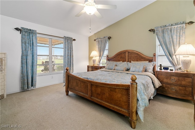 carpeted bedroom featuring multiple windows, ceiling fan, and vaulted ceiling