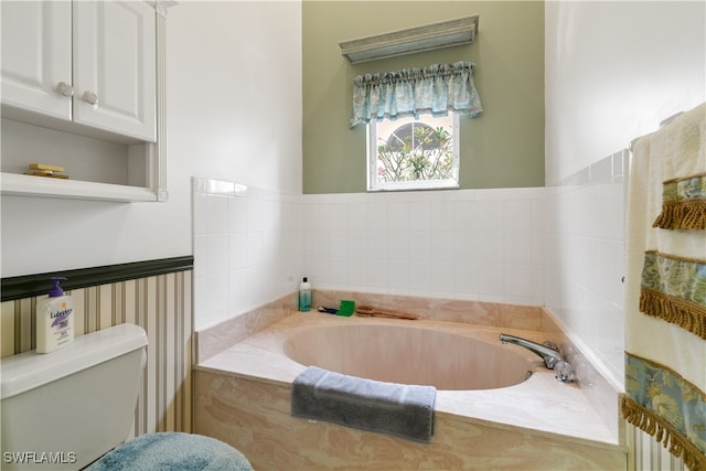 bathroom with tiled bath and toilet