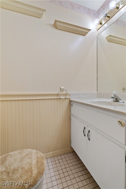 bathroom with vanity, wooden walls, and tile patterned floors