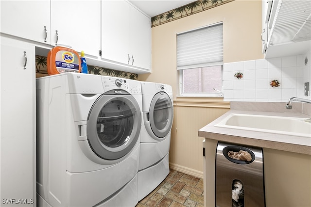 laundry area with cabinets, sink, and independent washer and dryer