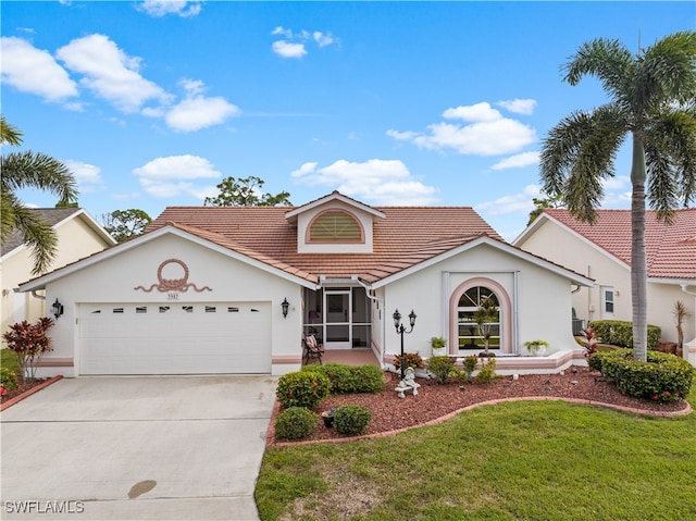 view of front of house with a garage and a front lawn