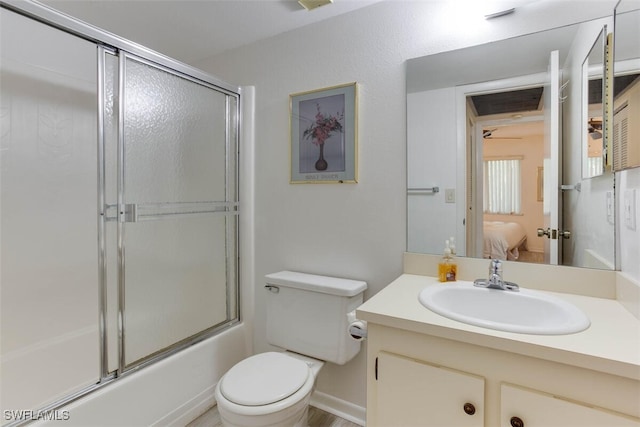 full bathroom with vanity, combined bath / shower with glass door, and toilet