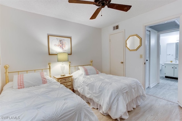 4351 27th Ct SW Unit 203, Naples, FL 34116 - bedroom featuring wood finished floors, connected bathroom, and a ceiling fan