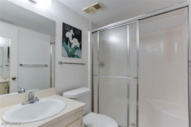 4351 27th Ct SW Unit 203, Naples, FL 34116 - full bathroom with vanity, a stall shower, and toilet