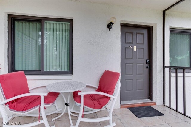 4351 27th Ct SW Unit 203, Naples, FL 34116 - doorway to property with stucco siding