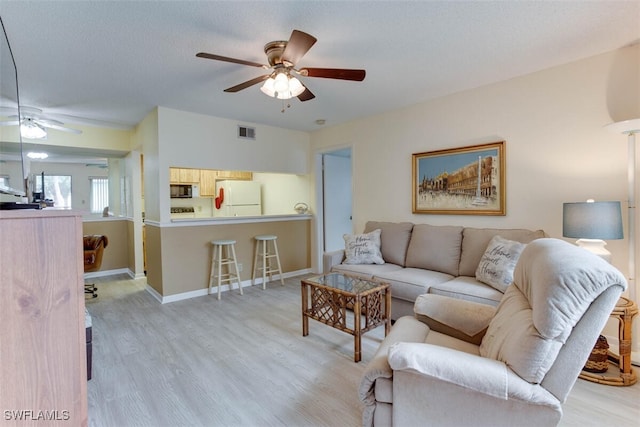 4351 27th Ct SW Unit 203, Naples, FL 34116 - living area with ceiling fan, light wood-style flooring, and baseboards