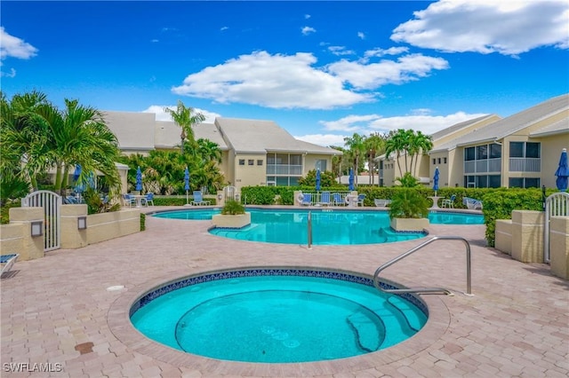 view of swimming pool featuring a patio area and a community hot tub