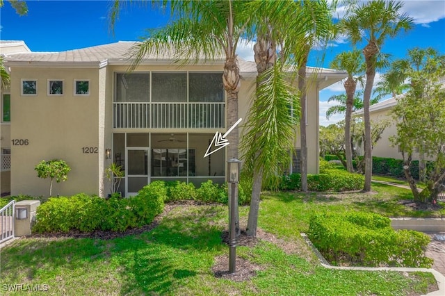 rear view of property featuring a lawn