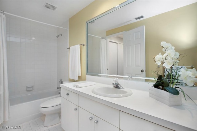 bathroom featuring tile patterned flooring, toilet, visible vents, vanity, and shower / bath combo with shower curtain