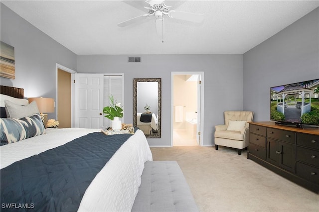 bedroom featuring baseboards, visible vents, a ceiling fan, light colored carpet, and ensuite bath