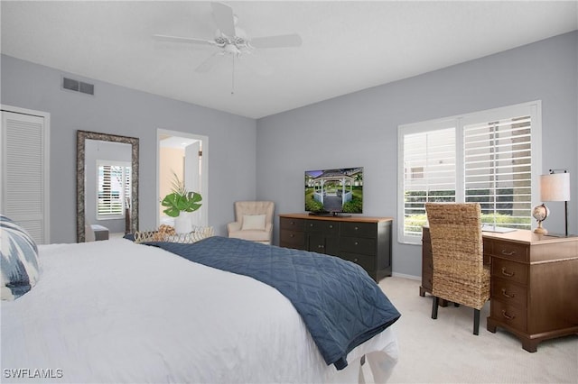 bedroom featuring a closet, ceiling fan, and light colored carpet