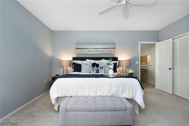 bedroom featuring light colored carpet, ceiling fan, and baseboards