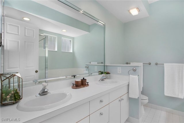 full bathroom with tile patterned flooring, a sink, toilet, and double vanity