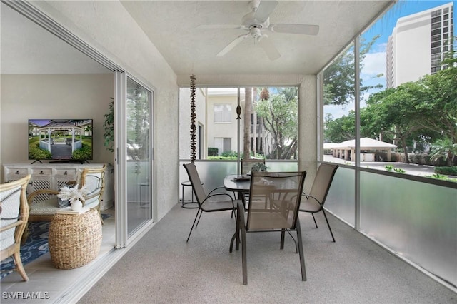 sunroom / solarium featuring ceiling fan