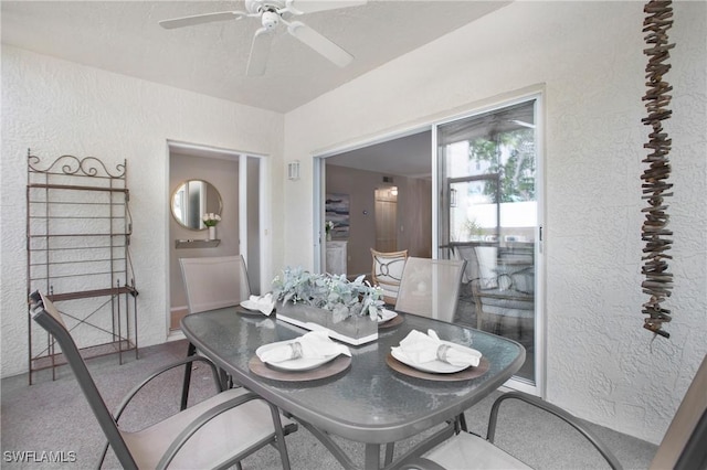 dining room with a textured wall and ceiling fan