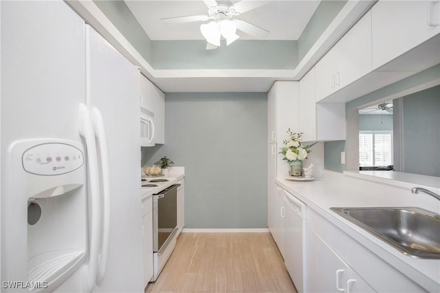 kitchen with ceiling fan, sink, light hardwood / wood-style flooring, white appliances, and white cabinets