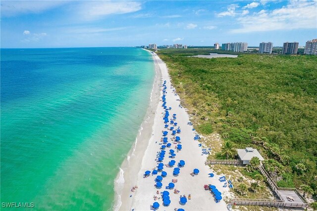 drone / aerial view featuring a beach view and a water view