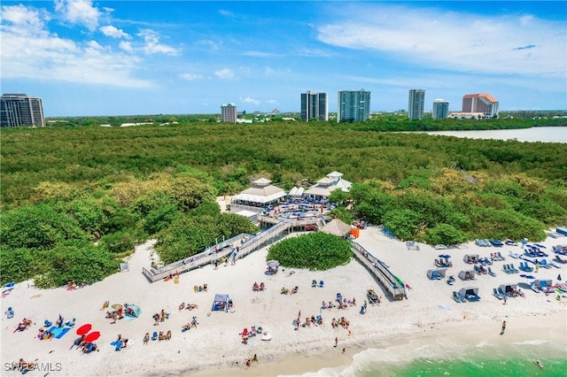 bird's eye view featuring a water view, a view of the beach, and a city view