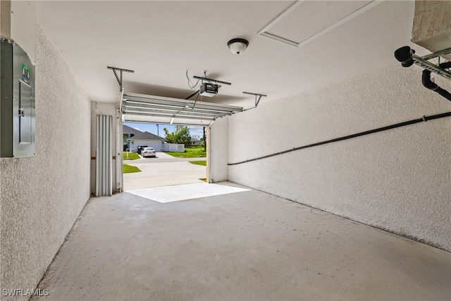 garage featuring a garage door opener and electric panel