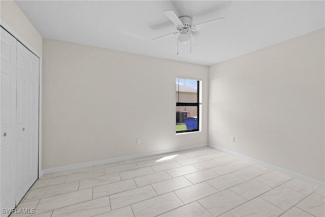 unfurnished bedroom featuring ceiling fan and a closet