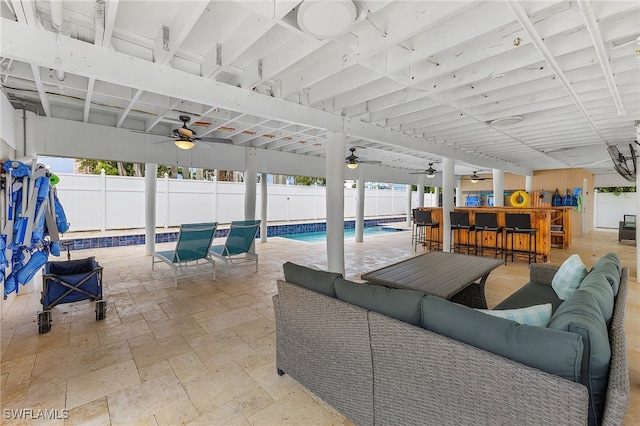 view of patio with an outdoor bar, ceiling fan, a fenced in pool, and an outdoor hangout area