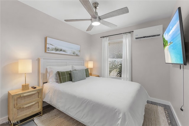 bedroom featuring a wall unit AC, ceiling fan, and wood-type flooring