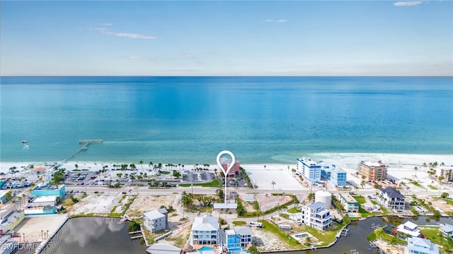 birds eye view of property with a view of the beach and a water view