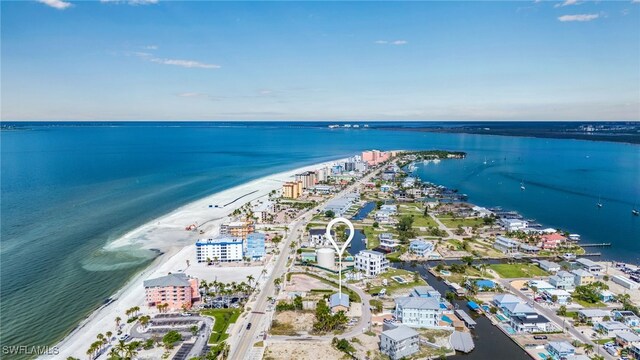 birds eye view of property featuring a water view and a beach view