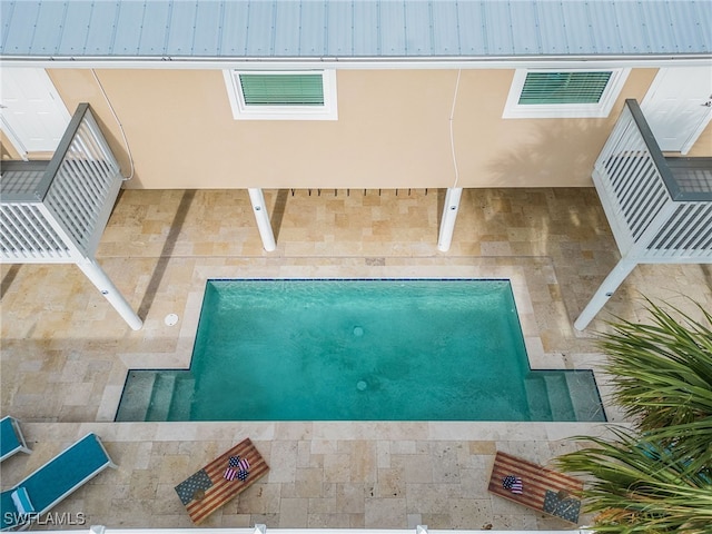 view of swimming pool with a patio