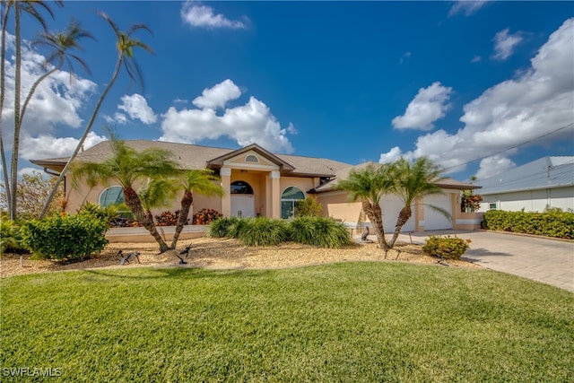 view of front of home with a garage and a front lawn