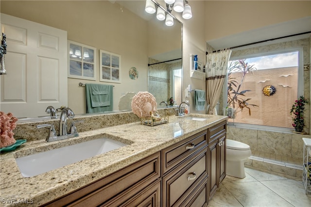 bathroom featuring toilet, vanity, tile patterned floors, and a shower with curtain