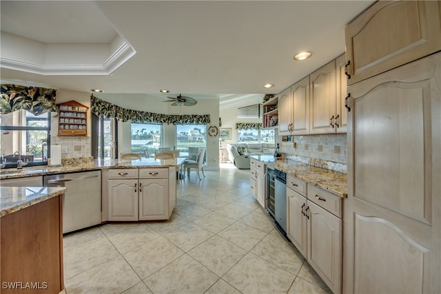 kitchen featuring tasteful backsplash, stainless steel dishwasher, light stone countertops, and ceiling fan