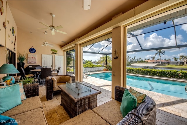 sunroom / solarium with a swimming pool, ceiling fan, and lofted ceiling