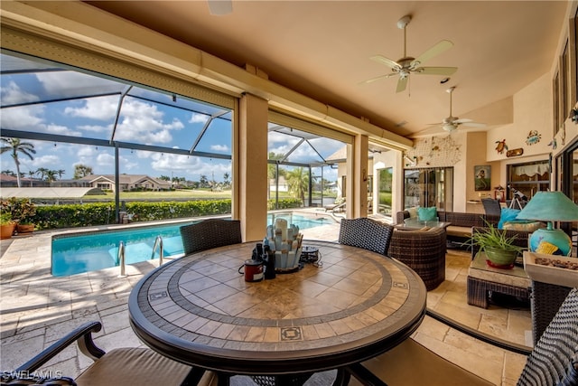 sunroom / solarium with lofted ceiling, ceiling fan, and a swimming pool